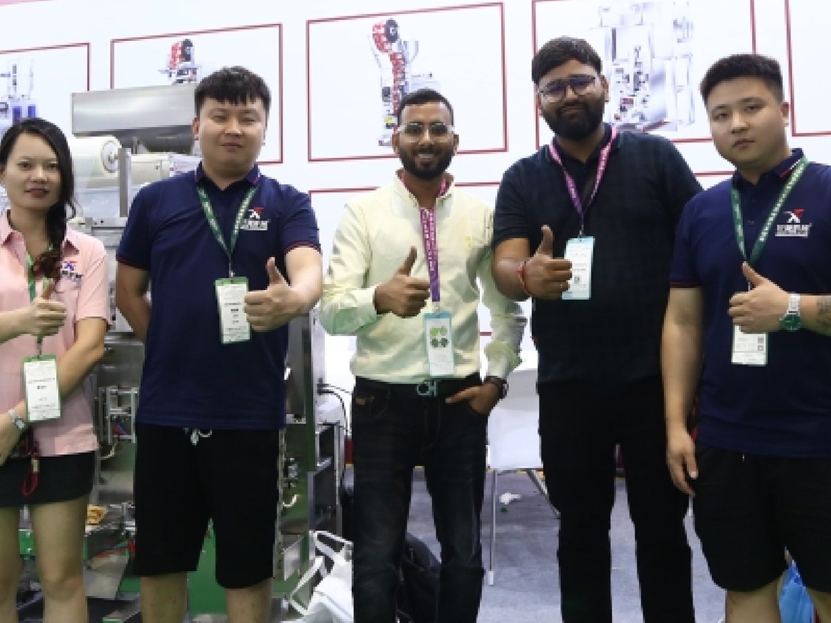South Asian buyers giving thumbs-up at our booth